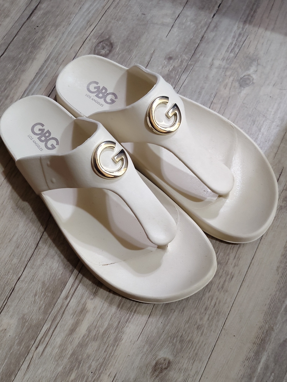 GBG Los Angeles Cream Thong Sandals with Gold Logo Accent